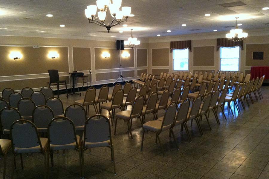 Ballroom set theater style with rows of chairs for a meeting