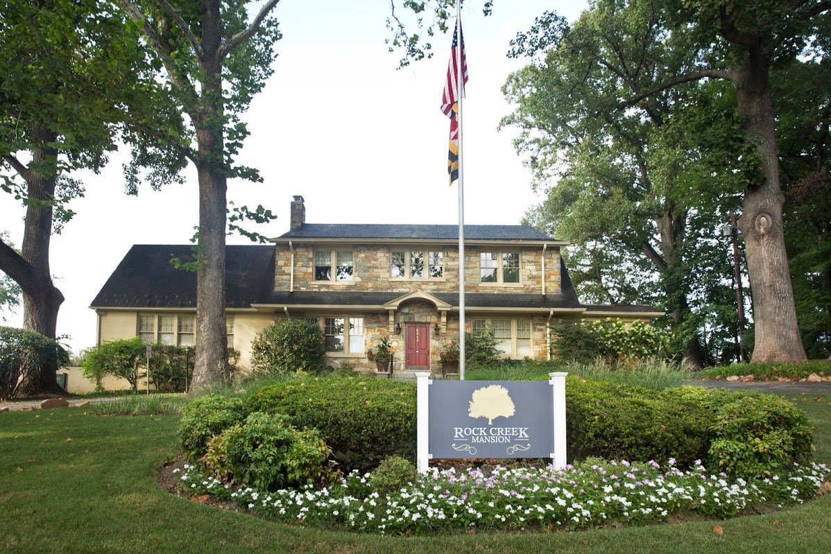 Rock Creek Mansion entrance sign and stone facade